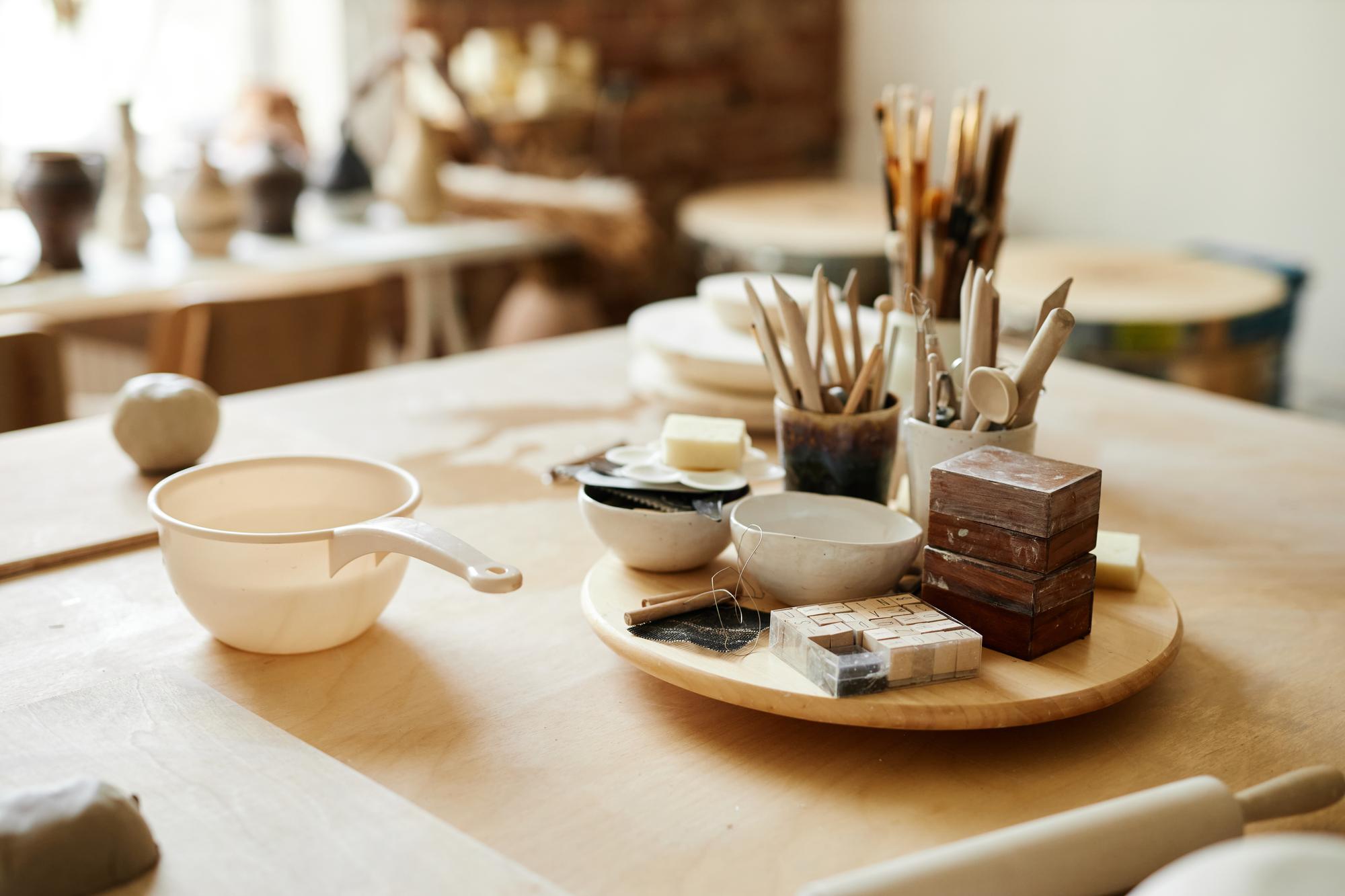 Interior of culinary studio with wooden table and utensils