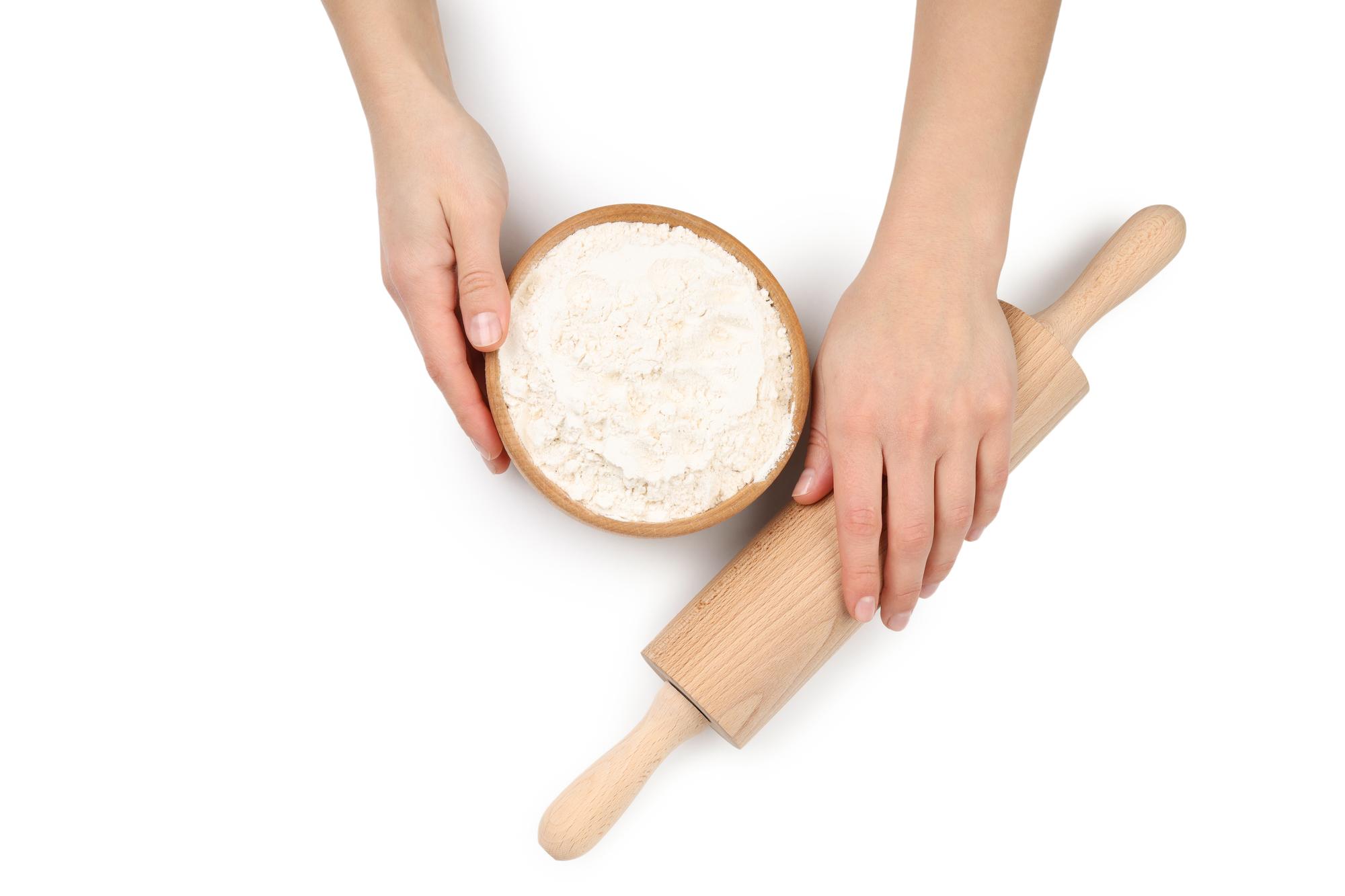 Student kneading dough on a floured board